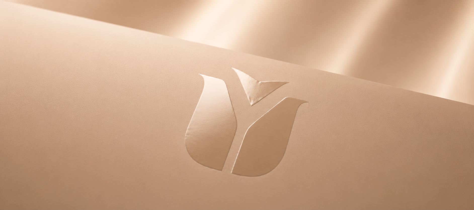 Dettaglio monogram Sinergy su superficie champagne